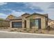 Beautiful single-story home featuring stone accents, a two-car garage, and desert landscaping at 138 Crimson Cactus Ave, Henderson, NV 89011