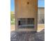 Outdoor fireplace area on the covered patio with brick flooring at 138 Crimson Cactus Ave, Henderson, NV 89011