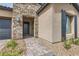 Charming stone accents and a brick walkway lead to the welcoming front entrance at 138 Crimson Cactus Ave, Henderson, NV 89011