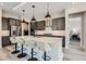 Modern kitchen with stainless steel appliances, quartz countertops, and an island with seating at 138 Crimson Cactus Ave, Henderson, NV 89011