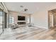 Spacious living room with fireplace, recessed lighting, ceiling fan, and wood flooring at 138 Crimson Cactus Ave, Henderson, NV 89011