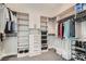This spacious walk-in closet has custom shelves, rods, and drawers to keep clothes organized and accessible at 138 Crimson Cactus Ave, Henderson, NV 89011