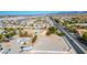 Birds eye view featuring a yard with a pool and an expansive lot in a residential area with clear desert views at 1410 E Serene Ave, Las Vegas, NV 89123
