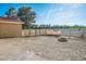 Spacious dirt backyard with block wall and chain-link fence at 1410 E Serene Ave, Las Vegas, NV 89123