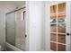 Bright bathroom features a shower-tub combo and a glass-paneled door to the outside at 1410 E Serene Ave, Las Vegas, NV 89123