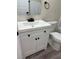 Stylish bathroom vanity with white cabinets, contrasting hardware and solid surface countertops at 1410 E Serene Ave, Las Vegas, NV 89123