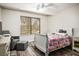 Cozy bedroom features wood floors, a large window, and comfortable seating at 1410 E Serene Ave, Las Vegas, NV 89123