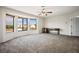 Spacious carpeted bedroom featuring a ceiling fan and large windows with neighborhood views at 1410 E Serene Ave, Las Vegas, NV 89123