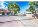 View of extended driveway with a dirt lot area and a partial view of the home at 1410 E Serene Ave, Las Vegas, NV 89123