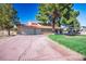 Spacious single-story home featuring an attached three-car garage, well-maintained lawn, and mature shade trees at 1410 E Serene Ave, Las Vegas, NV 89123