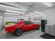 Spacious garage features a vibrant red classic car parked inside at 1410 E Serene Ave, Las Vegas, NV 89123