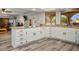 Spacious kitchen with white cabinets, granite countertops, and wood-style flooring at 1410 E Serene Ave, Las Vegas, NV 89123