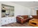 Cozy living room with a leather couch, wet bar, and wood-style flooring at 1410 E Serene Ave, Las Vegas, NV 89123
