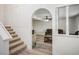 Cozy staircase and living room with an arched doorway and neutral decor at 1410 E Serene Ave, Las Vegas, NV 89123