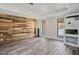 Large living room featuring modern wood accent wall and a white brick fireplace at 1410 E Serene Ave, Las Vegas, NV 89123