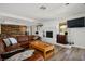 Spacious living room featuring a white brick fireplace and wood-style flooring at 1410 E Serene Ave, Las Vegas, NV 89123