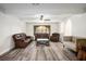Spacious living room featuring hardwood floors, neutral walls, and comfortable seating at 1410 E Serene Ave, Las Vegas, NV 89123