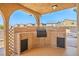 Outdoor kitchen featuring a built-in grill and ample storage space, perfect for entertaining at 1410 E Serene Ave, Las Vegas, NV 89123