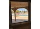 View of the pool from inside the house, featuring a fenced-in area and mature trees at 1410 E Serene Ave, Las Vegas, NV 89123