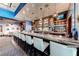 An inviting bar features marble countertops, white barstools, and a well-stocked selection of alcohol at 145 E Harmon Ave # 2411, Las Vegas, NV 89109