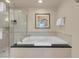 Bright bathroom featuring shower, soaking tub, art, and white towels at 145 E Harmon Ave # 2411, Las Vegas, NV 89109