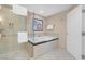 Relaxing bathroom with a soaking tub and a separate glass-enclosed shower at 145 E Harmon Ave # 2411, Las Vegas, NV 89109