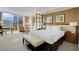 Bright bedroom features a comfortable bed, sitting area, and expansive windows offering city views at 145 E Harmon Ave # 2411, Las Vegas, NV 89109