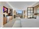 Bright bedroom features a comfortable bed, sitting area, and expansive windows offering city views at 145 E Harmon Ave # 2411, Las Vegas, NV 89109