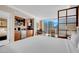 Bright bedroom features a comfortable bed, sitting area, and expansive windows offering city views at 145 E Harmon Ave # 2411, Las Vegas, NV 89109
