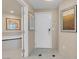 Neutral entryway featuring tile floors, framed art, and access to a luxurious bathroom with a soaking tub at 145 E Harmon Ave # 2411, Las Vegas, NV 89109