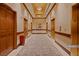 An elegant hallway showcasing carpet flooring, gold elevator doors, and warm lighting at 145 E Harmon Ave # 2411, Las Vegas, NV 89109