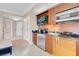 A modern kitchenette with stainless steel appliances, wooden cabinets, and granite countertops at 145 E Harmon Ave # 2411, Las Vegas, NV 89109