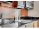 This kitchenette features a stainless steel sink and dark granite countertops at 145 E Harmon Ave # 2411, Las Vegas, NV 89109