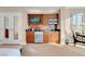This kitchenette features modern appliances, wooden cabinets, and granite countertops at 145 E Harmon Ave # 2411, Las Vegas, NV 89109