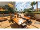 A serene patio featuring comfortable lounge furniture, string lights, and beautiful plants at 145 E Harmon Ave # 2411, Las Vegas, NV 89109
