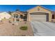 Charming single-story home featuring a two-car garage, desert landscaping, and a tiled roof at 1466 Fieldbrook St, Henderson, NV 89052