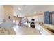 Bright kitchen featuring stainless steel appliances, granite countertops, and tile flooring throughout at 1466 Fieldbrook St, Henderson, NV 89052