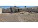 Cozy backyard featuring a covered patio, brickwork, fire pit, and hammock perfect for outdoor relaxation at 1645 Chestnut St, Henderson, NV 89011