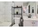 Clean bathroom featuring marble tile, a bathtub with shower, and modern black fixtures at 1645 Chestnut St, Henderson, NV 89011
