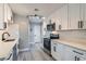 Modern kitchen features white cabinetry, stainless steel appliances, and sleek countertops at 1645 Chestnut St, Henderson, NV 89011