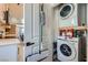 Modern laundry area with stacked washer and dryer, conveniently located with adjacent kitchen view at 1645 Chestnut St, Henderson, NV 89011