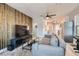 Bright living room features a modern design with a wooden accent wall, updated kitchen, and ample natural light at 1645 Chestnut St, Henderson, NV 89011