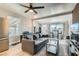 Bright living room with modern furniture, a stylish ceiling fan, and plenty of natural light at 1645 Chestnut St, Henderson, NV 89011