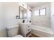 Bathroom with a tub, a sink, a window and a toilet at 1648 J St, Las Vegas, NV 89106