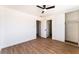 Clean bedroom featuring a ceiling fan, wood-look floors, and double closet at 1648 J St, Las Vegas, NV 89106