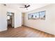 Spacious bedroom featuring a ceiling fan, wood-look floors, and a closet with sliding doors at 1648 J St, Las Vegas, NV 89106