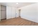Bedroom featuring wood-look floors, closet with sliding doors, and white walls at 1648 J St, Las Vegas, NV 89106