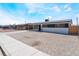 Single-story house with a low-maintenance gravel yard and neutral exterior paint at 1648 J St, Las Vegas, NV 89106