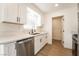 Bright kitchen featuring white cabinetry, quartz countertops, and stainless steel appliances at 1648 J St, Las Vegas, NV 89106