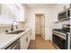 Modern kitchen featuring stainless steel appliances, white cabinets, and granite countertops at 1648 J St, Las Vegas, NV 89106